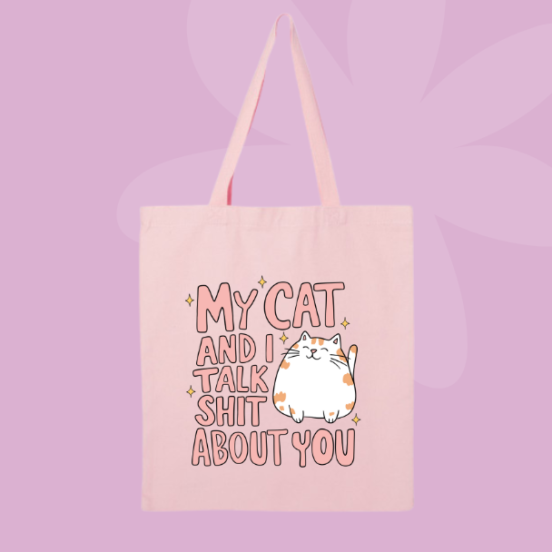 Funny cat quote tote bag with illustrated cat and text reading my cat and I talk shit about you.