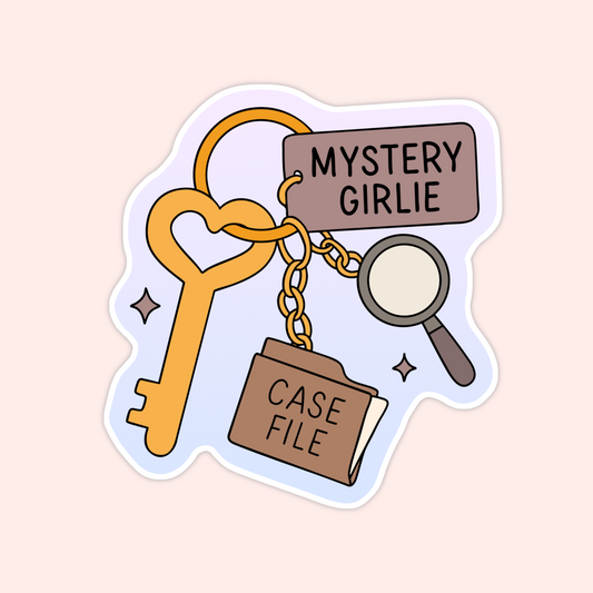 Pastel sticker showing a heart key with a “Mystery Girlie” tag, a magnifying glass charm, and a case file charm for cozy mystery readers.