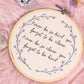 Hand embroidered quote hoop reading never be so kind you forget to be clever surrounded by delicate purple floral wreath