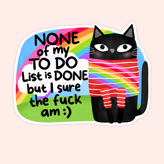 Black cat wrapped in a rainbow sweater next to the phrase “None of my to do list is done but I sure the fuck am.”
