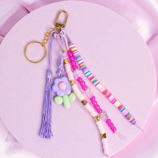 Pink and purple keychain with lavender flower charm, striped beads, and star accents.