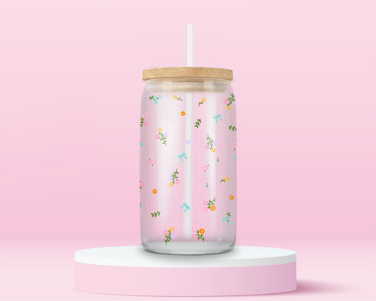 Pink glass tumbler with tiny scattered flowers and bows in a soft spring pattern.