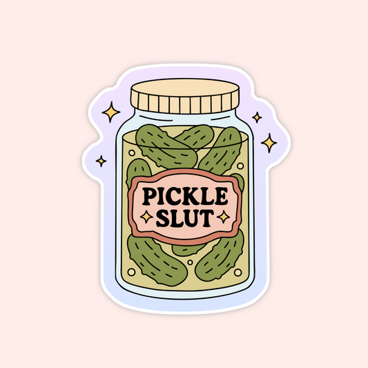 A pink-labeled glass jar full of pickles with bold text “Pickle Slut” in the center.