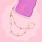 Pink cherry beaded phone wristlet with pastel beads, pink cherry charms, green leaf details, sparkly accents, and a gold phone strap attachment.