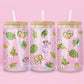 Glass can tumbler with bamboo lid and glass straw featuring potted plants, leafy greens, daisies, cacti, and botanical illustrations on a pink background.
