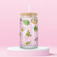 Glass can tumbler with bamboo lid and glass straw featuring potted plants, leafy greens, daisies, cacti, and botanical illustrations on a pink background.
