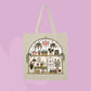 Beige canvas tote bag featuring a greenhouse-style plant shop illustration with potted plants, hanging greenery, watering cans, and botanical details.