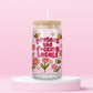 Glass can tumbler with bamboo lid and glass straw featuring flowers, bees, and bold pink text that says Protect The F*cking Locals on a pink background.
