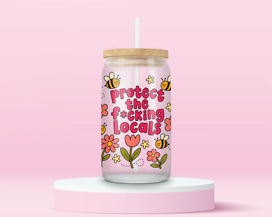 Glass can tumbler with bamboo lid and glass straw featuring flowers, bees, and bold pink text that says Protect The F*cking Locals on a pink background.