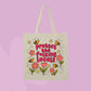 Beige canvas tote bag featuring flowers, bees, and bold pink text that says Protect The F*cking Locals.