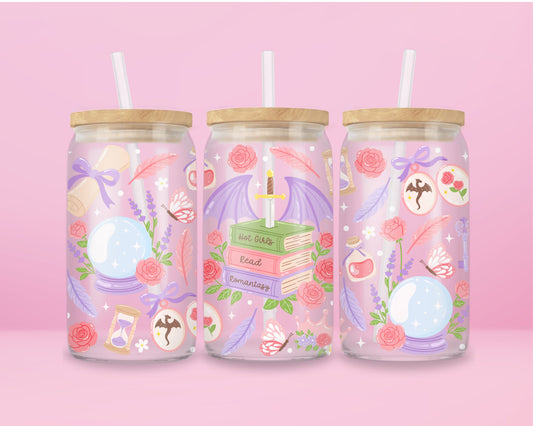 glass tumbler with fantasy details like stacked books, dragon wings, potion bottles, roses, feathers, and crystal balls.