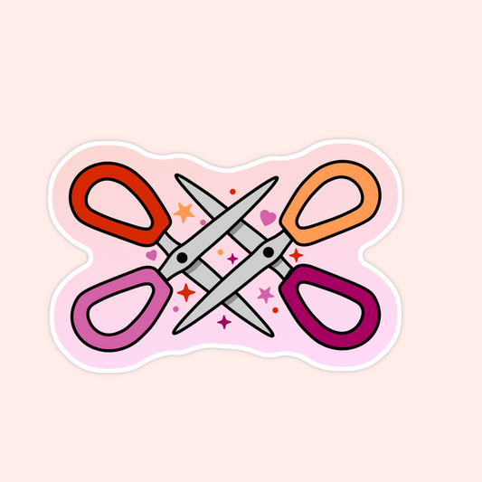 Sticker with two pairs of colorful scissors crossed together, surrounded by stars and hearts.