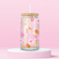 Glass can tumbler with bamboo lid and glass straw featuring seashells, starfish, citrus slices, hibiscus flowers, papaya, pearls, and seahorses on a pink background.