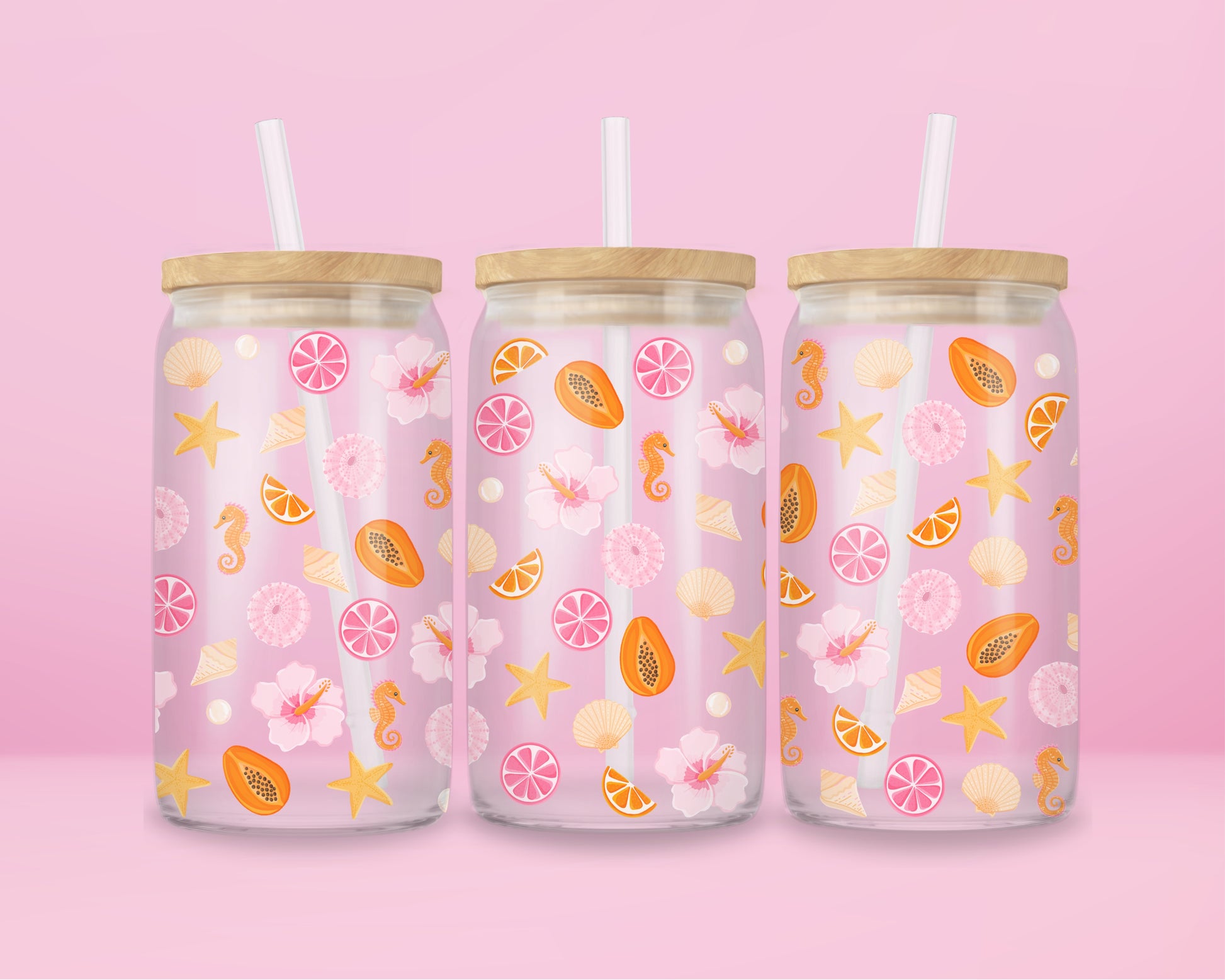 Glass can tumbler with bamboo lid and glass straw featuring seashells, starfish, citrus slices, hibiscus flowers, papaya, pearls, and seahorses on a pink background.