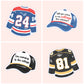 Illustrated Heated Rivalry sticker collection featuring hockey jerseys with numbers 24 and 81 and baseball caps referencing the cottage scenes.