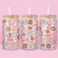 glass tumbler with repeating disco balls, showgirl corsets, cocktails, spotlights, and “T.S.” hearts.