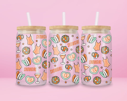 glass tumbler with repeating disco balls, showgirl corsets, cocktails, spotlights, and “T.S.” hearts.