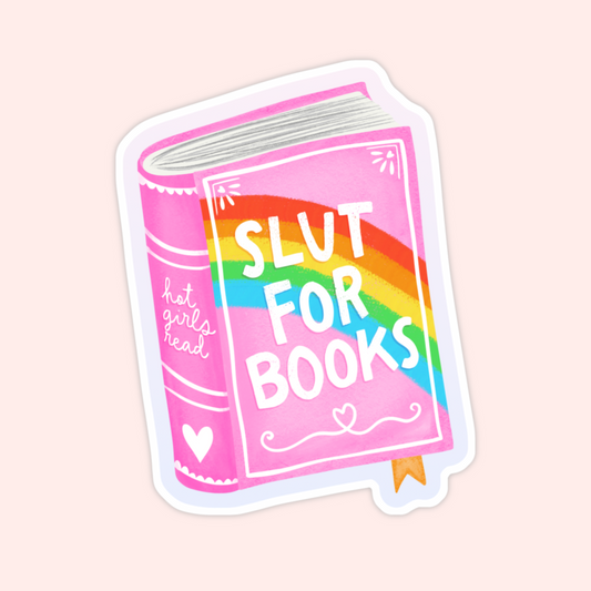 A bright pink book with a rainbow across the cover and the phrase “Slut for Books” in bold letters, with “Hot girls read” on the spine.