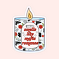 Sticker of a lit candle with the words “smells like mafia romance” surrounded by roses, gloves, cash, wine, and guns.