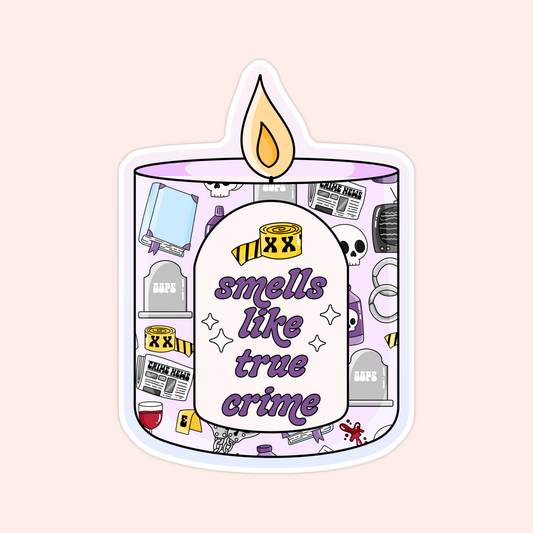 Sticker of a lit candle with the words “smells like true crime” surrounded by crime tape, skulls, handcuffs, and books.
