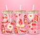 glass tumbler decorated with cherries, lips, masquerade masks, “Busy Reading Smut” book, and “Forbidden Love” signs.