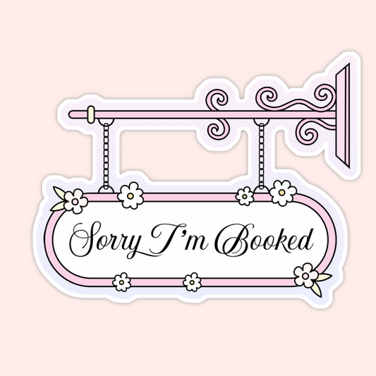 Vintage-inspired hanging sign with floral accents and the phrase “Sorry I’m Booked” in elegant script.