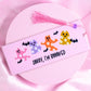 Pink bookmark with colorful flower-print ghosts, bats, and “Sorry I’m Booooked” text, with pink tassel.