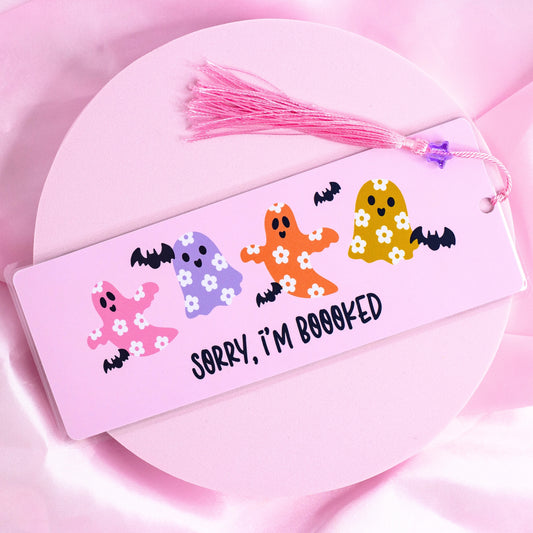 Pink bookmark with colorful flower-print ghosts, bats, and “Sorry I’m Booooked” text, with pink tassel.