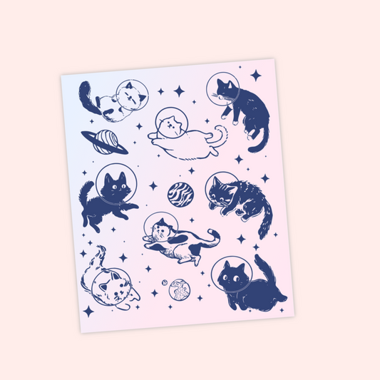 Sticker sheet of navy blue cats floating in space with planets and stars, wearing astronaut helmets.