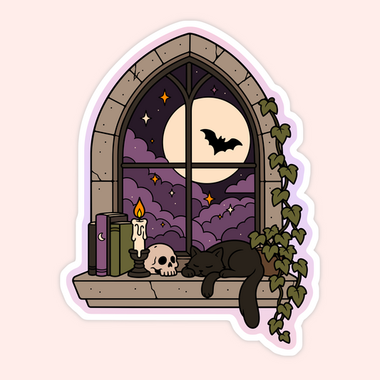 A die-cut sticker featuring a whimsical gothic illustration of a black cat sleeping on a stone windowsill beside a skull, candle, books, and ivy, with a full moon and bat visible through an arched window.