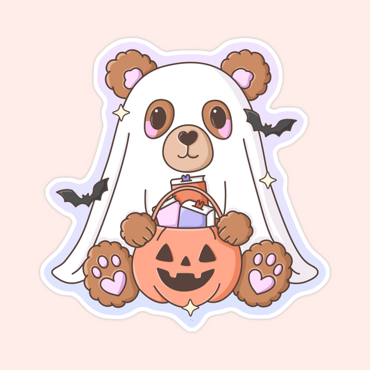 Brown teddy bear dressed as a ghost holding a jack-o’-lantern candy bucket with bats flying around.