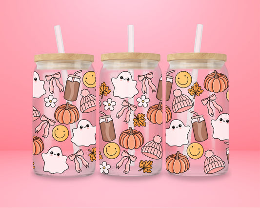 glass tumbler with ghosts, pumpkins, bows, smiley faces, coffee cups, and cozy fall details.