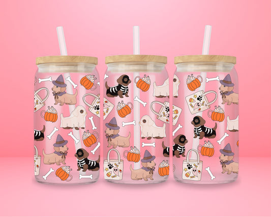 glass tumbler with dachshunds dressed as witches, ghosts, and skeletons alongside pumpkins, whipped lattes, tote bags, and bones.