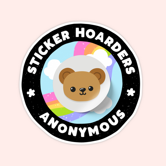 Round black sticker with a cute bear face in the center, rainbow clouds behind it, and the words "Sticker Hoarders Anonymous."