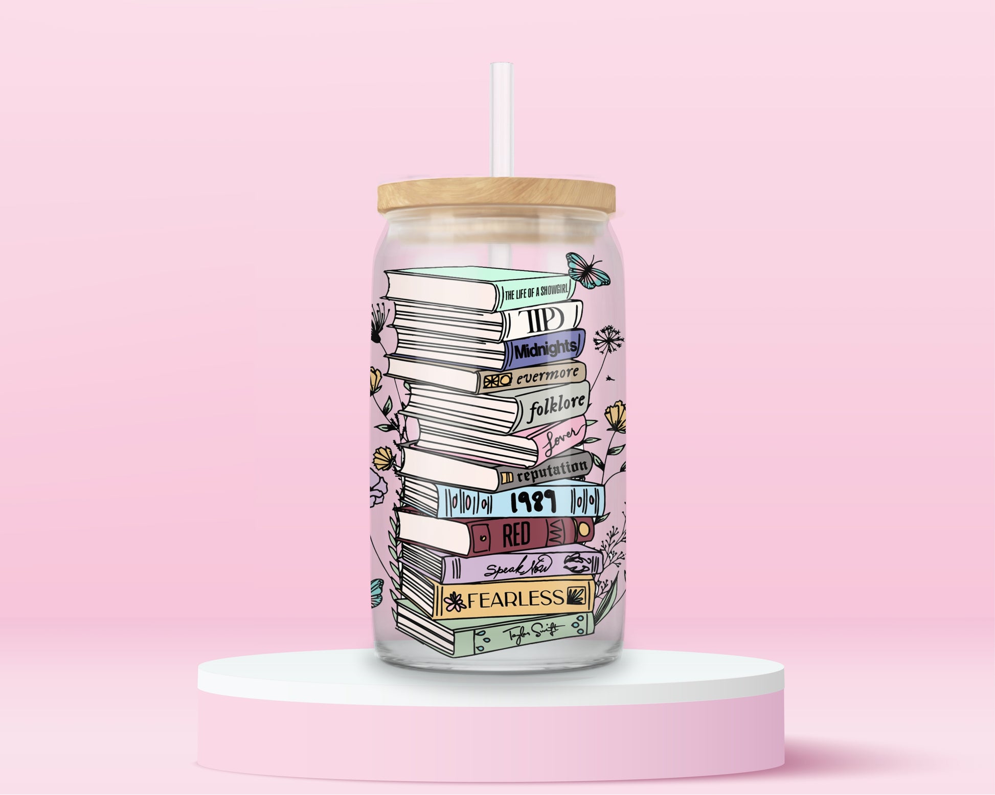 glass tumbler with stacked books labeled Taylor Swift albums like Fearless, Red, 1989, Folklore, Midnights, surrounded by flowers and butterflies.