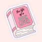 Pink illustrated book with the phrase “the life of a book lover” on the cover in a soft, girly aesthetic.