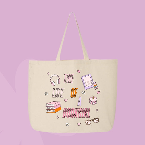 Beige tote bag with colorful pastel doodles of books, headphones, glasses, a candle, and text that says “The Life of a Bookgirl.”