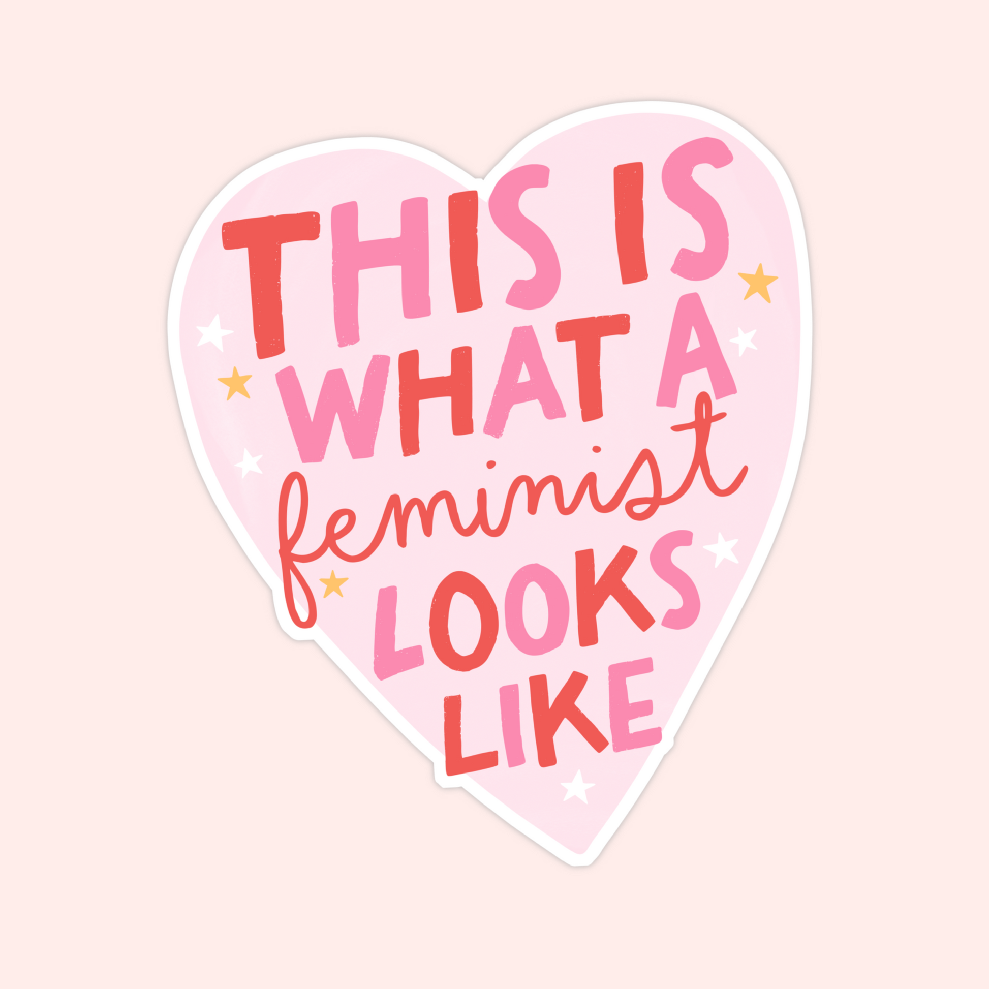 Pink heart-shaped sticker with the phrase "This is what a feminist looks like" in red and pink lettering.