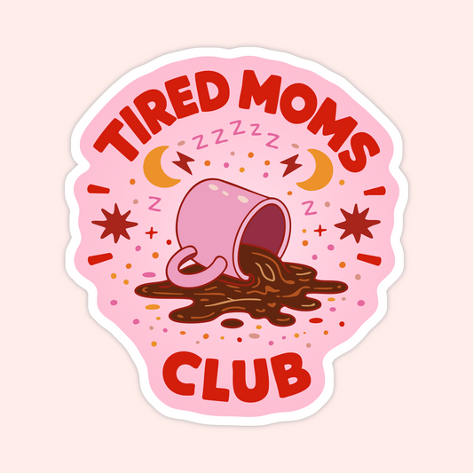 Pink sticker of spilled coffee mug with stars and moons that says “Tired Moms Club.”