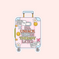 Sticker shaped like a pink suitcase with the words “I’ll unpack this in therapy later” and travel icons.