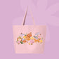 Large pink canvas tote bag featuring an orange cat, mushrooms, bluebell flowers, ladybugs, leafy stems, and woodland cottagecore illustrations.