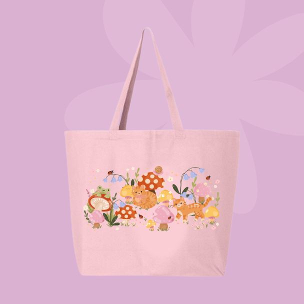 Large pink canvas tote bag featuring an orange cat, mushrooms, bluebell flowers, ladybugs, leafy stems, and woodland cottagecore illustrations.