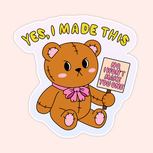 Cute vinyl sticker featuring a stitched teddy bear holding a sign that says “No I Won’t Make You One” with the phrase “Yes, I Made This.”