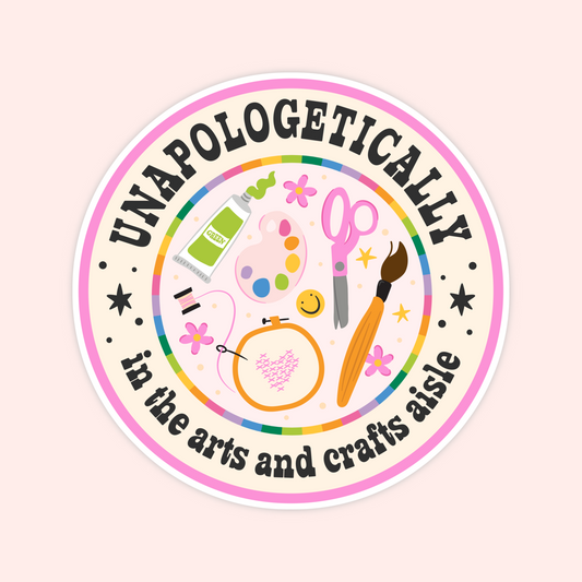 Round craft lover sticker reading “Unapologetically In The Arts And Crafts Aisle” with paint, scissors, embroidery and art supplies