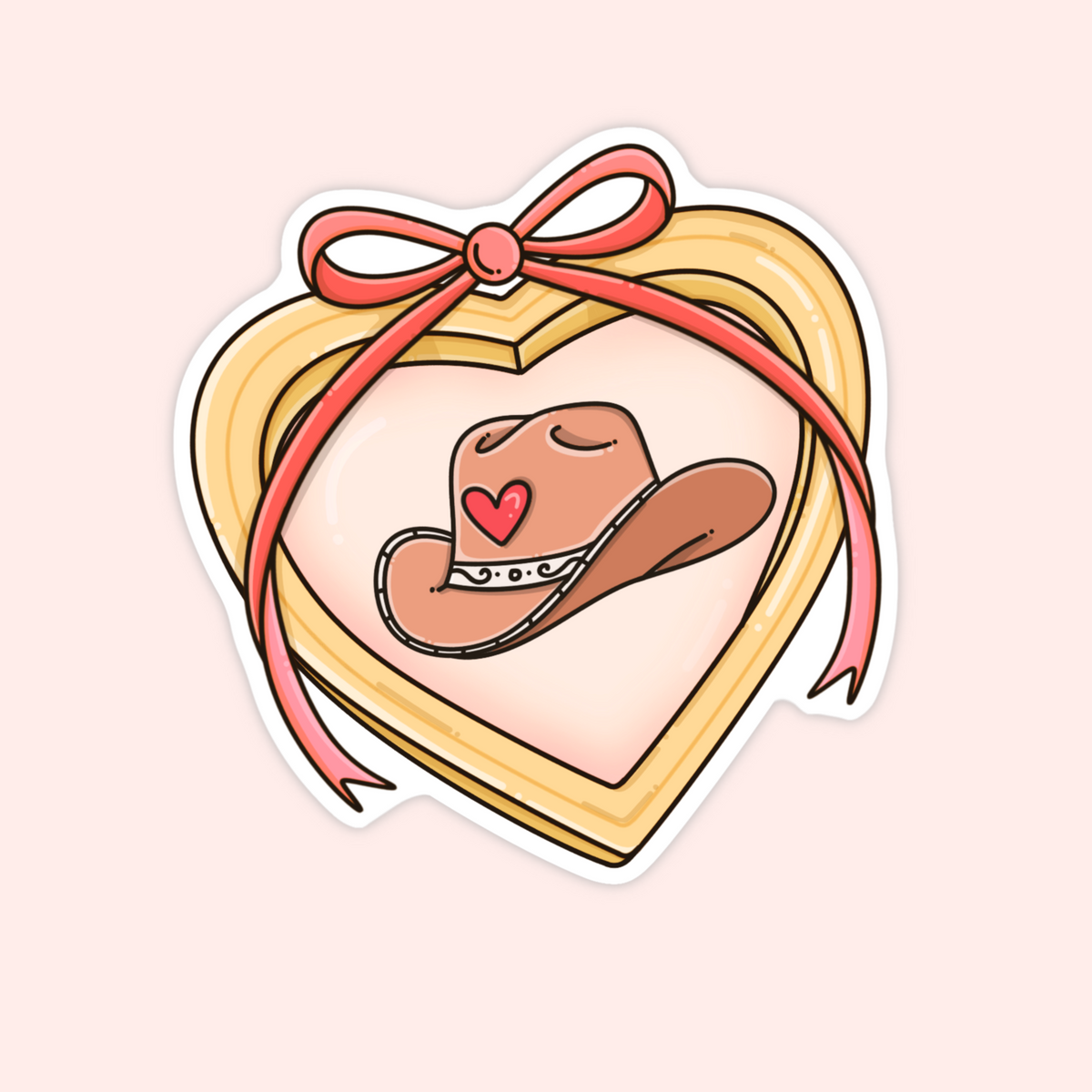 Heart-shaped gold locket with a pink ribbon and illustrated cowboy hat inside