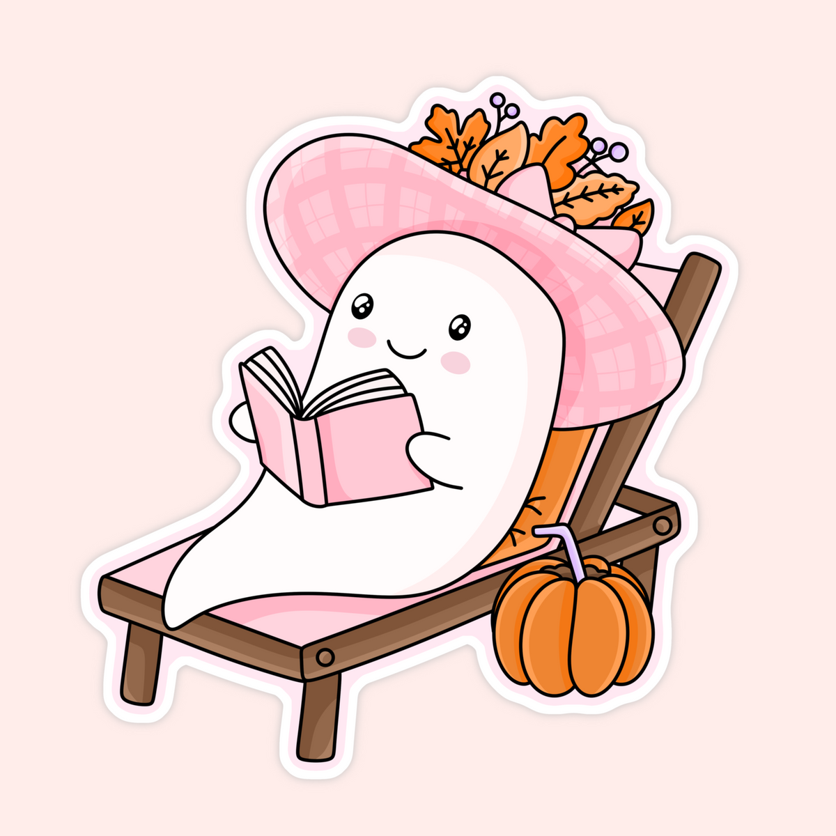 Cute ghost sticker featuring a little ghost reading a pink book while lounging on a chair with a pink hat, autumn leaves and a pumpkin.