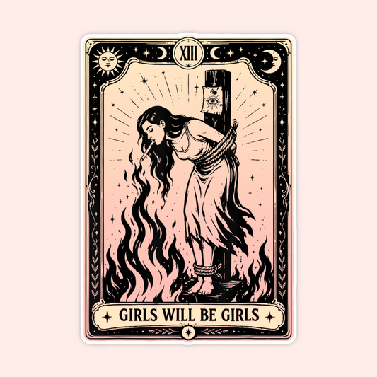 A tarot-style art print card featuring a vintage illustration of a girl bound to a pole with flames, surrounded by stars and moons. The card has a cream and black border with the text 'GIRLS WILL BE GIRLS' at the bottom, set against a solid pale pink background.