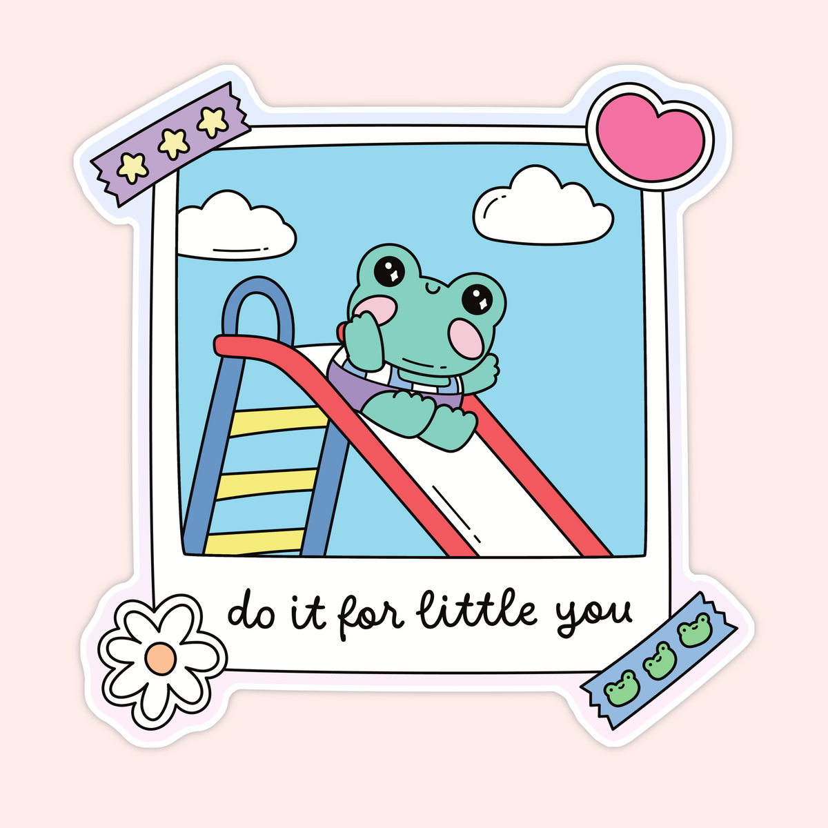 A die-cut sticker featuring a cute cartoon illustration of a green frog sliding down a red slide in a blue sky with clouds, styled like a Polaroid photo with decorative tape, a pink heart, a flower, and the text 'do it for little you'.