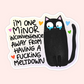 A die-cut sticker featuring a black cartoon cat with tears and the text 'I'M ONE MINOR INCONVENIENCE AWAY FROM HAVING A FUCKING MELTDOWN' on a pale pink background.