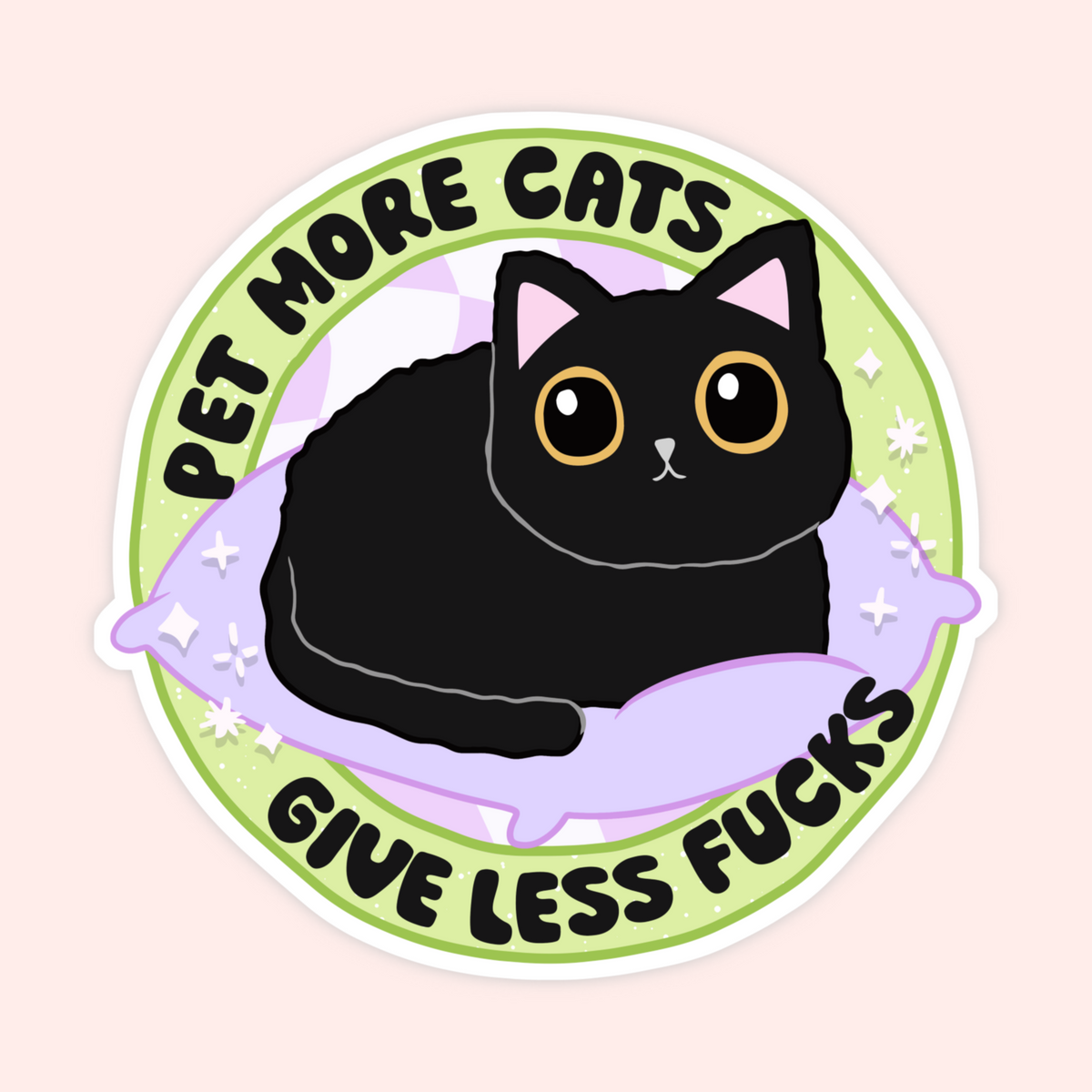 A die-cut circular sticker featuring a cartoon black cat lying on a lavender pillow, with the text 'PET MORE CATS' at the top and 'GIVE LESS FUCKS' at the bottom, shown on a pale pink background.